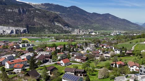 Establishing-drone-shot-over-swiss-town-with-modern-solar-panels-on-roof-of-houses