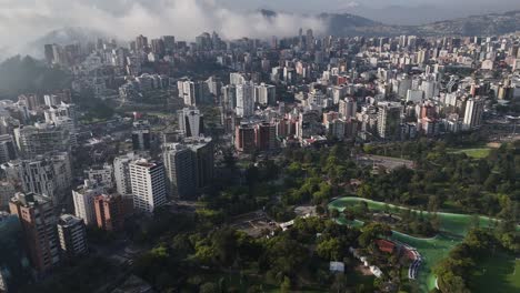 Aerial-drone-video-view-footage-of-Qutio-early-morning-sunrise-capital-city-of-Ecuador-La-Carolina-Park-traffic-Catedral-Metropolitana-de-Quito-south-american-skyline