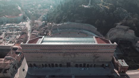 Dive-by-drone-into-one-of-the-most-beautiful-ancient-theaters-in-France,-that-of-the-city-of-Orange,-at-sunrise