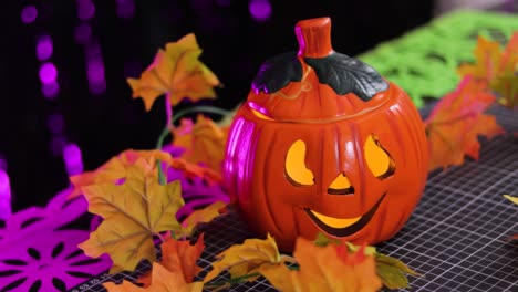 Colorful-halloween-decoration-with-carved-pumpkin-in-the-shape-of-a-jack-o-lantern