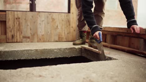 Timelapse-Of-A-Man-Cutting-Wooden-Plank-With-A-Handsaw-For-The-Greenhouse