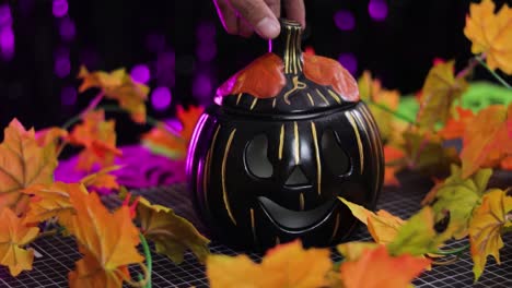 Black-pumpkin-as-a-Halloween-decoration-with-a-candle-inside