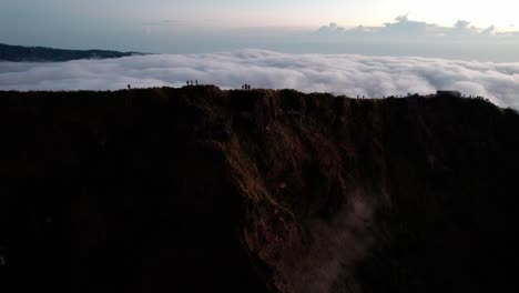 Tourists-Hiking-Mount-Batur-In-Bali,-Indonesia---Drone-Shot