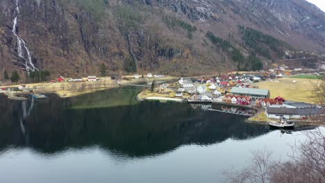 Revealing-idyllic-town-Mo-in-Modalen-Norway-from-behind-tree