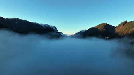 Morning-haze-at-sunrise-with-Veafjord-in-background,-Norway-aerial