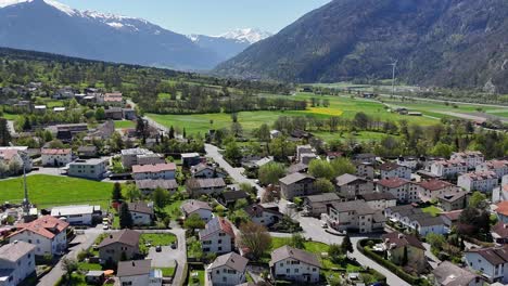 Quaint-idyllic-landscape-of-Trimmis-Town-in-Switzerland-with-homes-and-buildings-in-sunlight