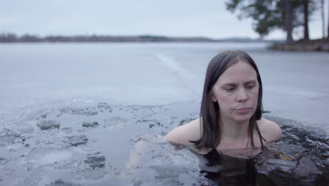 A-woman-in-her-40s-finishes-her-daily-ice-bathe-and-exits-the-lakewater