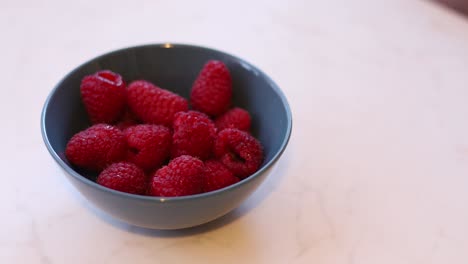 Juicy-red-ripe-raspberries-in-a-blue-bowl