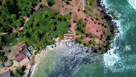 Aerial-drone-view-of-Mirissa-Point-bay-village-with-Coconut-tree-hill-palm-plantation-headland-coastline-Weligama-Sri-Lanka-Asia-travel-tourism-Indian-Ocean