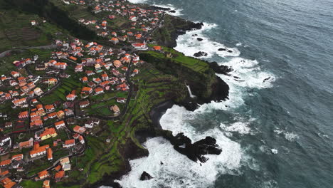 Aerial-view-overlooking-the-Seixal-town-in-cloudy-Porto-Moniz,-Madeira