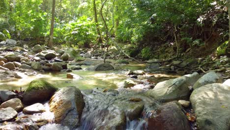 Aerial-image-of-a-stream-amidst-small-rock-formations-in-Santa-Marta,-Colombia