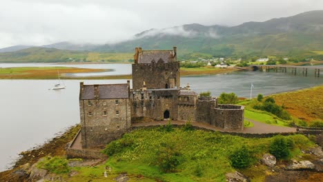 Close-up-aerial-pan-around-Eilean-Donan-castle,-national-landmark-and-13th-century-building-in-the-Scottish-highlands,-Scotland