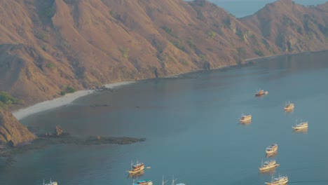 Boats-anchored-in-beautiful-bay-of-Padar-island,-Komodo-archipelago,-Indonesia