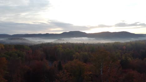 aerial-view-of-foggy-morning-forest-landscape-with-mountains-peak-and-sunshine-magic-mystic-landscape