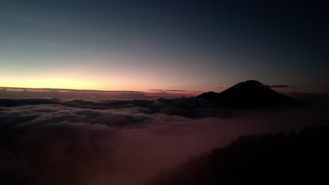 Mount-Batur-Volcano-Over-Sea-Of-Clouds-At-Sunset-In-Bali,-Indonesia