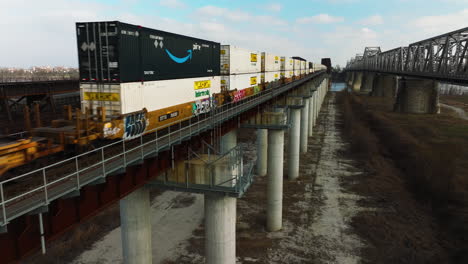 Intermodal-Containers-On-Freight-Cargo-Train-Traveling-Through-Elevated-Railroad-In-West-Memphis,-Tennessee,-USA