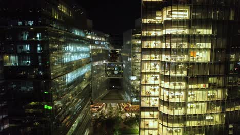 Drone-Aerial-buildings-offices-at-Night-Nueva-Las-Conde-Santiago-Chile-Town-at-nighttime,-Administrative-commercial-downtown