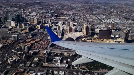 Las-Vegas-USA-Airplane-Passenger-Point-of-View-Over-Wing,-Strip-Casino-Hotel-Buildings