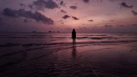 Contemplative-silhouette-of-a-woman-at-dusk-on-Koh-Samui,-Thailand