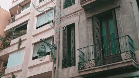 street-lantern-hanging-on-the-corner-of-a-building-in-the-city-center-of-Barcelona