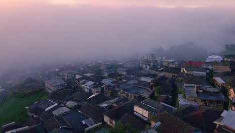 Sunrise-above-the-clouds-on-village-housing-and-fog-in-the-morning