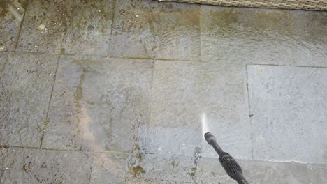Cleaning-paving-stones-in-backyard-using-high-pressure-water-cleaner