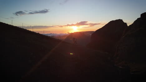 couple,-walking-trail-during-sunset-in-Madeira,-golden-hour-in-high-altitude-mountains