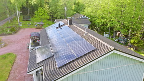 Photovoltaic-cells-generating-electricity-on-a-private-house-roof---Aerial-view