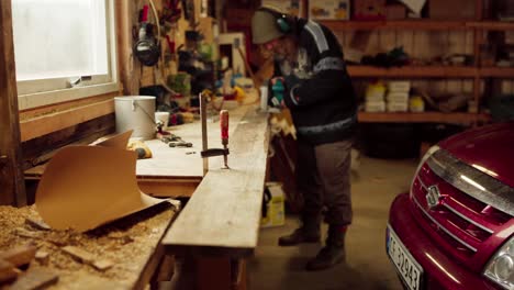 Man-Cutting-Wooden-Board-With-Electric-Saw-Tool---Close-Up