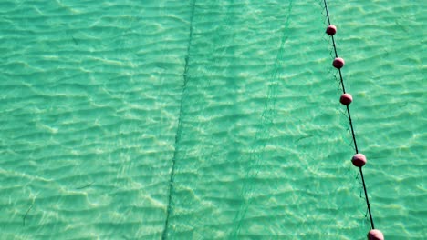 Net-Fishing-in-the-Aegean-Sea:-Aerial-View-of-a-Traditional-Trap-in-Thessaloniki's-Blue-Waters