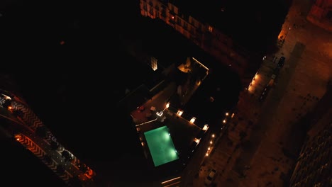 Above-View-Of-Rooftop-Restaurant-With-Swimming-Pool-In-Malaga,-Andalusia,-Spain-At-Night
