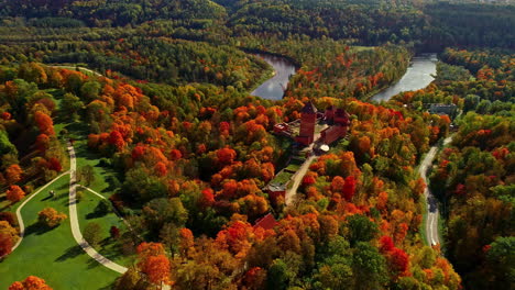 Aerial-View-Of-Turaida-Castle,-Dense-Forest-And-Gauja-River-In-Autumn-In-Vidzeme,-Latvia