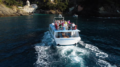 Aerial-view-following-the-Golfo-Paradiso-tour-ferry-approaching-the-San-Fruttuoso-abbey,-in-Italy