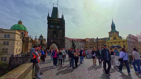 Slowmotion-view-of-tourism-walking-of-a-bridge-in-the-historical-city-centre-of-Prague