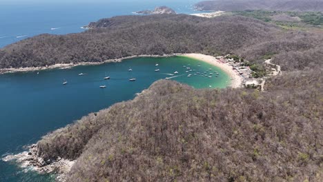 Aerial-view-of-beaches-in-Huatulco,-Playa-El-Maguey-visible-in-distance