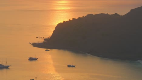 Silhouette-Von-Fischerbooten,-Die-Bei-Sonnenuntergang-Auf-Der-Insel-Padar-In-Indonesien-Vor-Anker-Liegen