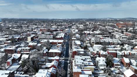 Aerial-view-of-a-snow-covered-American-cityscape-with-rows-of-houses-and-road
