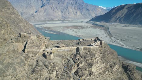 Drone-shot-of-Kharpocho-fort-in-Skardu-City,-Pakistan-during-daytime