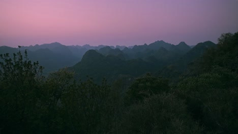 Static-shot-of-Limestone-mountains-during-pinkish-sky-sunset-in-Cat-BA-Island-of-Vietnam