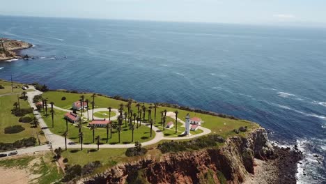 4K-Aerial-View-of-Point-Vicente-Lighthouse-won-the-Cliffs-with-Waves-Crashing-over-the-Pacific-Ocean-on-a-Warm,-Sunny-Day