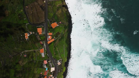 topview-drone-shot-of-Sao-Vicente-village,-sea,-waves,-from-above,-Madeira-aerial-view