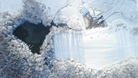 Pond-Surrounded-By-Snow-covered-Land-in-Winter