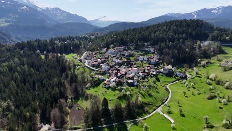 Idyllic-small-town-on-green-mountain-in-Switzerland-at-sunlight