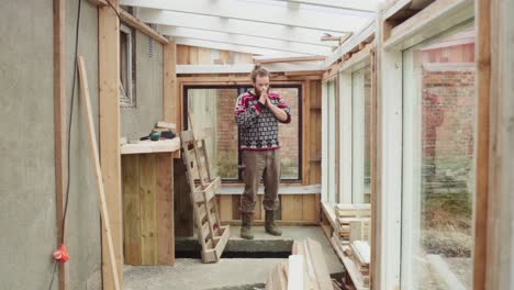 Timelapse---Man-Sweeping-Inside-The-Newly-Construct-Greenhouse-With-Glass-Window