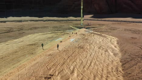 Aerial-view-away-from-a-person-revealing-the-Maraya-concert-hall,-in-Saudi-Arabia---Pull-back,-drone-shot