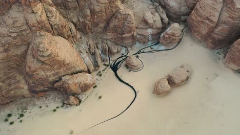 Aerial-view-of-the-Muhannad-Shono-"The-Lost-Path",-at-Desert-X-AlUla,-Saudi-Arabia---circling,-drone-shot