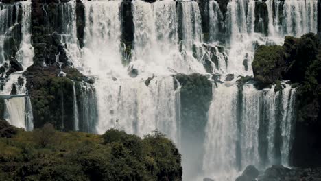 Iguazu-Falls-With-Staircase-Character-Flowing-Down-The-River-In-Brazil