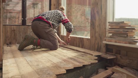 Man-Assembling-Wood-Planks,-Building-DIY-Greenhouse---Close-Up