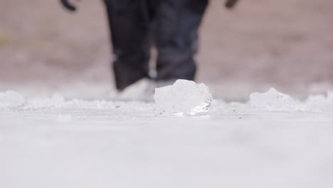 Scuba-diver-in-dry-suit-walks-into-subzero-icy-frozen-lake-for-ice-dive