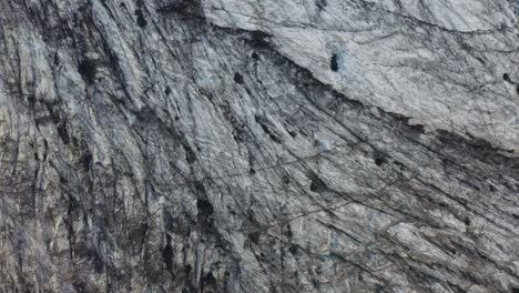 Aerial-top-down-view-unveils-the-stunning-glacial-formations-of-Sólheimajökull,-Iceland-majestic-glaciers